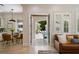 Open living room with tile floors and views of the outdoor pool through open doors at 2211 Azalea Pl, Winter Park, FL 32789
