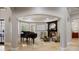 Elegant living room with a fireplace, grand piano, and comfortable seating area at 2211 Azalea Pl, Winter Park, FL 32789