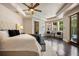 Luxurious main bedroom with a sitting area, hardwood floors, and pool views at 2211 Azalea Pl, Winter Park, FL 32789