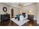 This main bedroom boasts dark wood floors, a decorative ceiling fan, and a decorative mirror at 2211 Azalea Pl, Winter Park, FL 32789