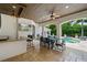 Outdoor dining area featuring a bar, large dining table, and a view of the pool and spa at 2211 Azalea Pl, Winter Park, FL 32789
