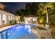 Inviting backyard pool and spa area with bar and lounge seating under the stars at night at 2211 Azalea Pl, Winter Park, FL 32789