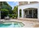 Stunning outdoor space features a private pool and covered patio with dining area at 2211 Azalea Pl, Winter Park, FL 32789