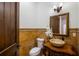 This powder room has unique tiling, a vessel sink, and a framed mirror above the sink at 2211 Azalea Pl, Winter Park, FL 32789