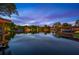 A waterfront view of the property with a dock, boathouse, and lift at 2211 Azalea Pl, Winter Park, FL 32789