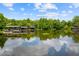Scenic view of a serene lake with private boat docks surrounded by lush greenery at 2211 Azalea Pl, Winter Park, FL 32789