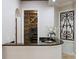 Stylish wet bar area with granite countertops and custom wine storage at 2211 Azalea Pl, Winter Park, FL 32789