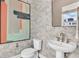 Modern powder room featuring stylish textured walls, a sleek pedestal sink, and abstract artwork at 2273 Valentine Aly, Orlando, FL 32804