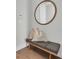 Inviting entryway with a bench, decorative pillows, and a stylish round mirror at 2273 Valentine Aly, Orlando, FL 32804