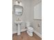 A compact half bath features a pedestal sink and a modern mirror at 2273 Valentine Aly, Orlando, FL 32804