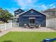 Charming backyard featuring a patio with outdoor seating and artificial grass, perfect for entertaining and relaxing at 2604 Marble Ave, Orlando, FL 32803