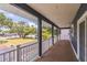 Inviting balcony with dark columns and wood floors, offering a view of the neighborhood at 2604 Marble Ave, Orlando, FL 32803