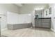 Bathroom featuring a tiled tub, a modern vanity with storage, and a well-lit space at 2604 Marble Ave, Orlando, FL 32803