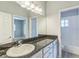Bathroom featuring a dark countertop vanity with a view to the neighboring bedroom at 2604 Marble Ave, Orlando, FL 32803