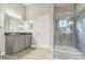 Modern bathroom featuring gray cabinets, granite countertops, and glass enclosed shower with gray tiling and plank flooring at 2604 Marble Ave, Orlando, FL 32803