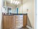 Bathroom with oak vanity and dark granite countertop, with view of bedroom and toilet at 2604 Marble Ave, Orlando, FL 32803