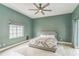 Comfortable bedroom featuring stylish decor, a ceiling fan, and a serene atmosphere at 2604 Marble Ave, Orlando, FL 32803