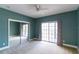 Teal bedroom featuring sliding glass door to the patio and mirrored closet at 2604 Marble Ave, Orlando, FL 32803
