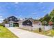 Charming two-story home featuring a bright blue door, white picket fence, and spacious driveway on a sunny day at 2604 Marble Ave, Orlando, FL 32803