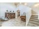 Welcoming foyer boasts an open layout, staircase, tiled floors and transitions to an arched opening at 2604 Marble Ave, Orlando, FL 32803