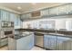 The blue kitchen is open to the Gathering room and features stainless appliances and lots of counter space at 2604 Marble Ave, Orlando, FL 32803