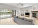 Bright living room with a stone fireplace and sliding glass doors to the pool at 2604 Marble Ave, Orlando, FL 32803