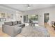 Inviting living room featuring tile floors, a gray couch, and access to the pool area at 2604 Marble Ave, Orlando, FL 32803