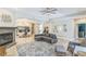 Spacious living room featuring a cozy fireplace, stylish decor, and tile floors at 2604 Marble Ave, Orlando, FL 32803