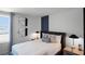 Comfortable bedroom featuring a plush bed, decorative wall accents, and stylish bedside lamps at 2696 Gouda Dr, Apopka, FL 32703