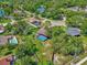 Aerial view showcasing a desirable neighborhood with mature trees, and a backyard pool at 3 Pine Glen Dr, Debary, FL 32713