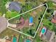 Aerial view of property featuring a screened pool, home, and spacious, tree-filled lot at 3 Pine Glen Dr, Debary, FL 32713