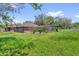 Lush backyard featuring mature landscaping and a charming brick home, creating a serene and inviting outdoor space at 3 Pine Glen Dr, Debary, FL 32713
