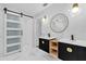 Modern bathroom features double sinks with black fixtures, custom cabinets, and marble-look tile at 3 Pine Glen Dr, Debary, FL 32713