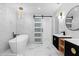 Modern bathroom features a freestanding tub, double vanities, and beautiful marble-look tile at 3 Pine Glen Dr, Debary, FL 32713
