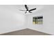 Bright bedroom featuring light gray laminate flooring, a modern ceiling fan, and a view to the backyard at 3 Pine Glen Dr, Debary, FL 32713
