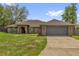 Charming brick home featuring an attached two-car garage and well-maintained landscaping at 3 Pine Glen Dr, Debary, FL 32713
