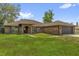 Charming brick home featuring an arched entryway, a two-car garage, and lovely curb appeal at 3 Pine Glen Dr, Debary, FL 32713