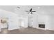 Open living room with new ceiling fan, fireplace and lots of natural light from back windows at 3 Pine Glen Dr, Debary, FL 32713