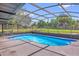 Inviting pool with screen enclosure, offering a refreshing outdoor oasis with ample sunlight and relaxation space at 3 Pine Glen Dr, Debary, FL 32713