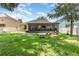 Expansive backyard features a lush lawn, a swing, and a screened-in patio for outdoor enjoyment at 30308 Cheval St, Mount Dora, FL 32757