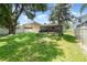 Lush backyard features a well-maintained lawn, a fire pit, and a swing, perfect for outdoor activities at 30308 Cheval St, Mount Dora, FL 32757