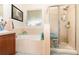 Bathroom featuring a bathtub and separate glass enclosed shower at 30308 Cheval St, Mount Dora, FL 32757