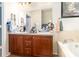 Bathroom featuring double vanity, bathtub, and a painting hung on the wall at 30308 Cheval St, Mount Dora, FL 32757