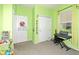 Bright green ' bedroom with a keyboard by the window and a dartboard on the door at 30308 Cheval St, Mount Dora, FL 32757