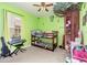 Bedroom with decor with bunk beds, keyboard, and green painted walls at 30308 Cheval St, Mount Dora, FL 32757