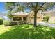 Well-maintained single-story home with lush green lawn and mature landscaping at 30308 Cheval St, Mount Dora, FL 32757