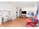 Spacious living room with wood floors, white walls, and a comfortable seating area with an entertainment center at 30308 Cheval St, Mount Dora, FL 32757