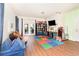 Inviting living room boasts with wood floors, a TV, and sliding glass doors to the back at 30308 Cheval St, Mount Dora, FL 32757