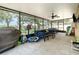 Spacious screened-in patio with ample seating and views of the backyard, perfect for outdoor gatherings at 30308 Cheval St, Mount Dora, FL 32757