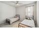 Bright bedroom featuring two metal beds and a ceiling fan at 3142 Hill Point St, Minneola, FL 34715